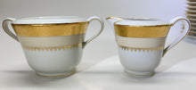 Charles Field Haviland 55-Piece Gold and Cream Rimmed Dinnerware for Seven to Ten.