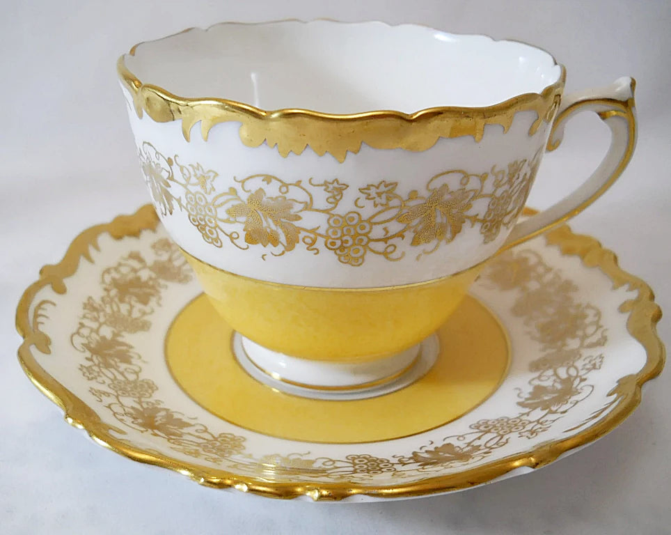 Coalport Hazelton England Gold Gilt and Yellow Bone China Teacup and Saucer Set.