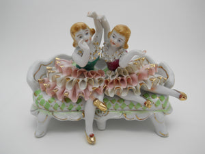 Ruffled Dress Girls On Couch 7" Porcelain Figurine
