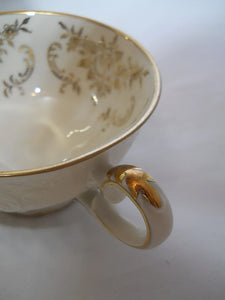 Zeh Scherzer & Co. Bavaria Ivory and Gold Porcelain Teacup and Saucer Pair.